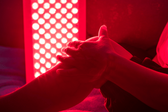 A woman receives red light therapy treatment